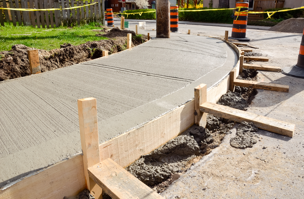 Recently poured sidewalk with forms still in place - Quillen Construction Group