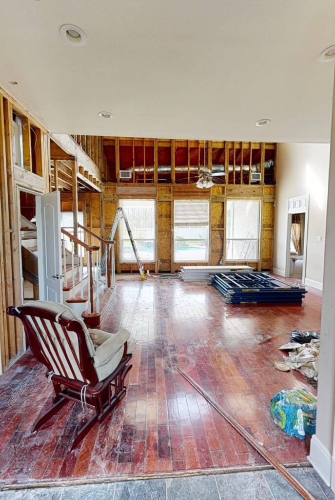 A pre-restoration living space, transformed by Quillen Construction Group in New Orleans, after hurricane damage.