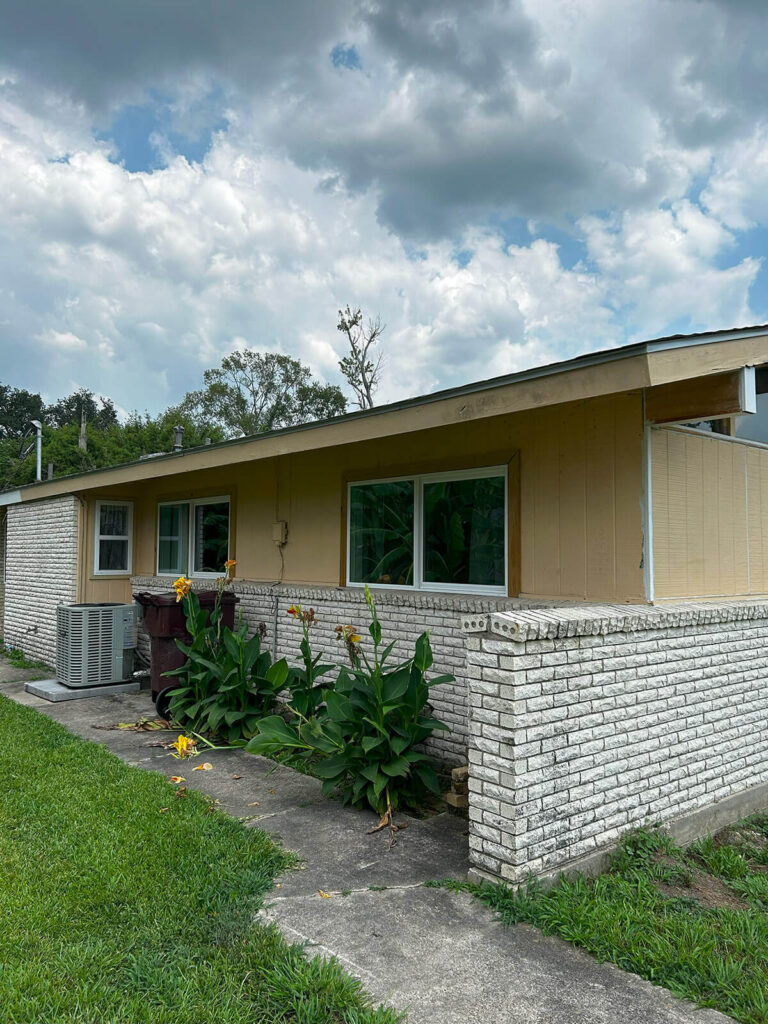 A before picture of a home, before undergoing exterior painting in New Orleans by Quillen Construction Group.