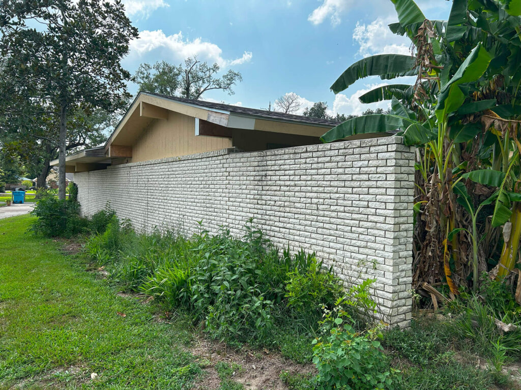 A before picture of a home, before undergoing exterior painting in New Orleans by Quillen Construction Group.