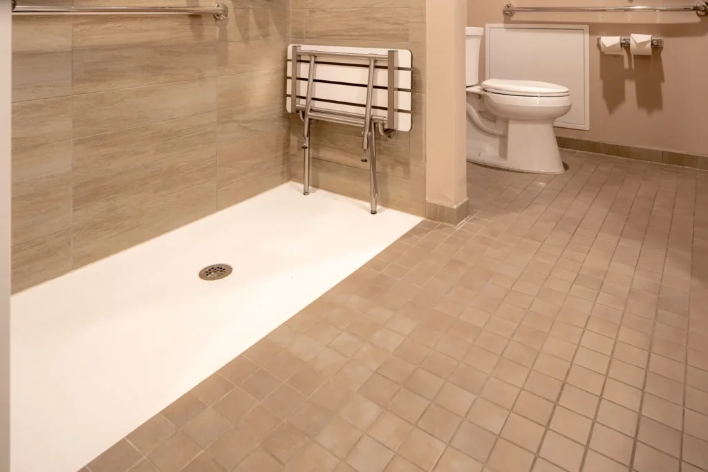 A picture of an ADA compliant bathroom, with a shower and toilet in the background for the blog "The Guide to ADA Compliant Bathroom Remodels in New Orleans".