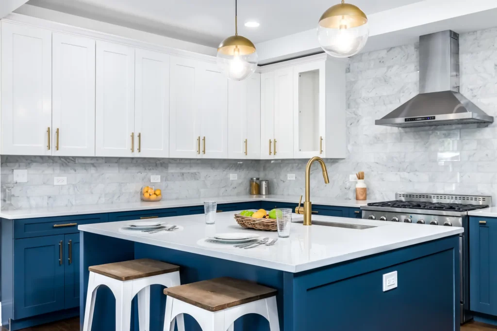 How much should a 10x10 kitchen remodel cost? - A picture of a remodeled kitchen in New Orleans. Navy / blue cabinets, barstools, custom backsplash, etc.