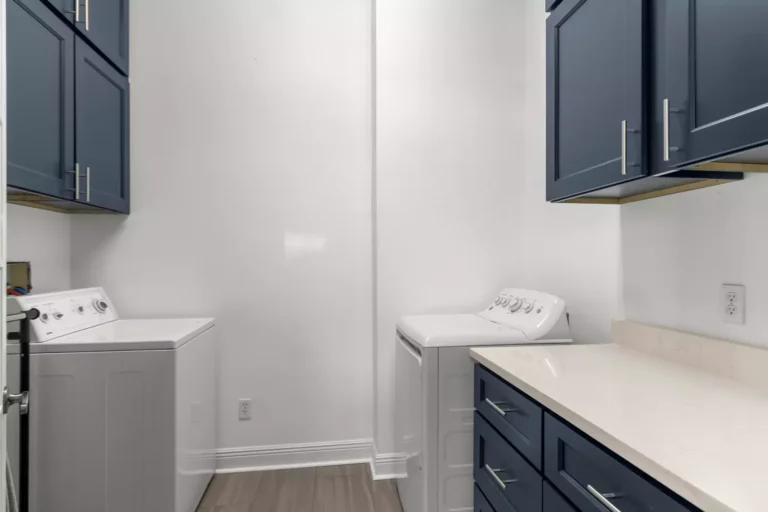 new laundry room with blue cabinets